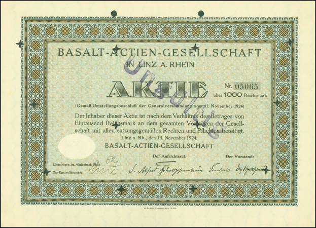 Ein gerahmtes altes Aktienzertifikat der Basalt-Actien-Gesellschaft in Linz, Deutschland, mit darauf geschriebenem Text.