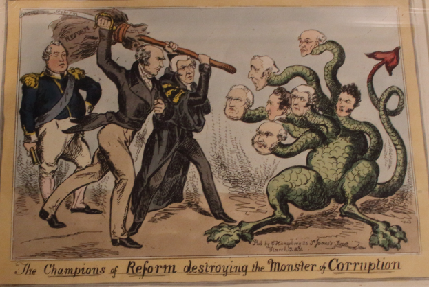 Eine Karikatur auf einem Blatt, das Reformchampions zeigt, die ein Monster namens 'Korruption' besiegen, mit der Beschriftung 'Die Reformchampions zerstören das Monster der Korruption.'