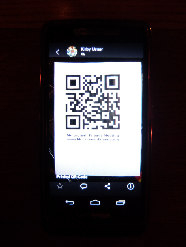 Ein Mobiltelefon mit einem QR-Code auf dem Bildschirm.